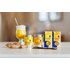 A photo of a turmeric latte. Next to it are two cans of turmeric latte and two packs of turmeric latte.