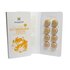 In the photo you can see an open white package. Inside are orange colored Manuka Drops. 