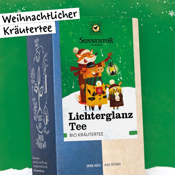 Illustrated packaging of "Lichterglanz Tea" by Sonnentor, organic herbal tea with a winter scene and animal figures