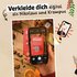 Hand holding smartphone, text: "Dress up digitally as Nikolaus and Krampus"