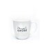 Photo of a white tea cup with the words Sonnige Grüße on it.