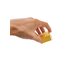 The spreader insert is held folded in one hand and shines in sunny yellow with the SONNENTOR logo on it.